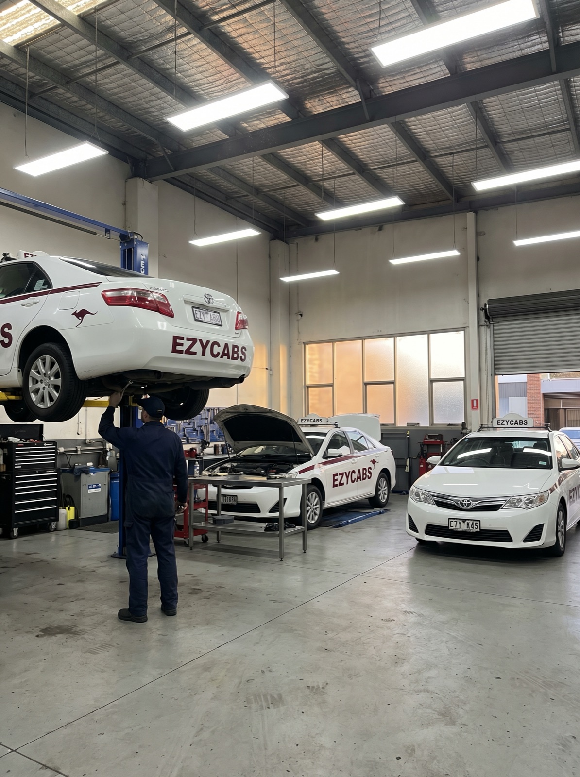 EZY CABS workshop in Fyshwick — vehicles being serviced on hoists